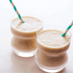 Two walnut smoothies with straws