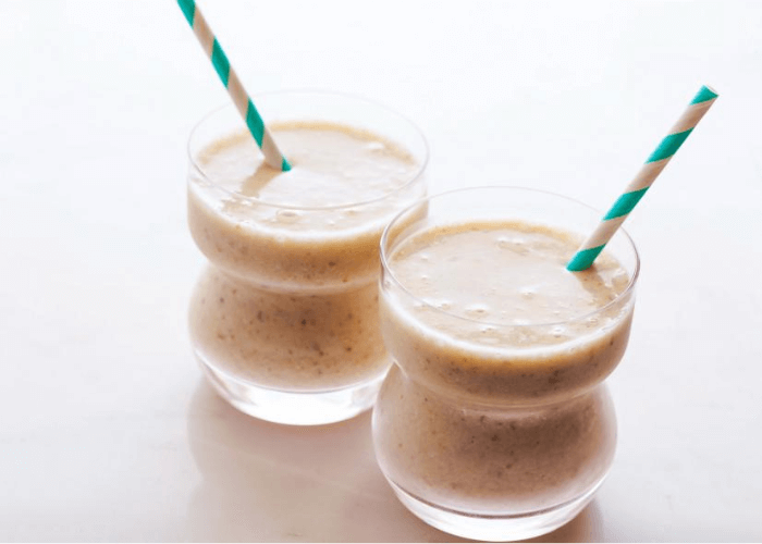 Two walnut smoothies with straws