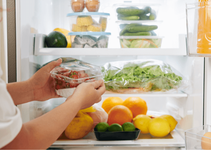 Hands going into a refrigerator
