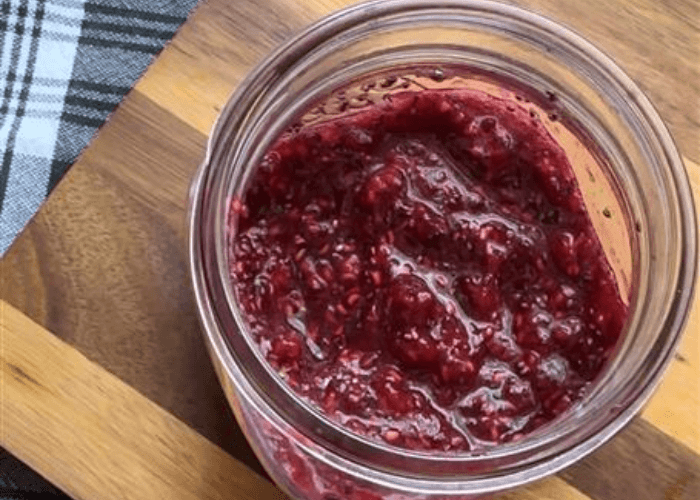 Homemade raspberry jam in a mason jar