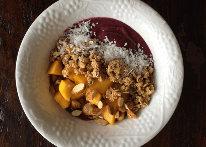 Acai smoothie bowl with granola, ginger, mango