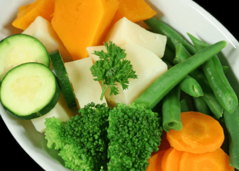 Dish with butter, broccoli, zucchini, carrots, green beans
