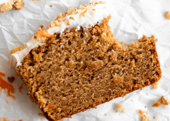Gluten-Free Carrot Cake with frosting and a bite taken out of it