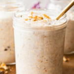 3 Carrot Cake Overnight Oats in mason jars with chopped walnuts