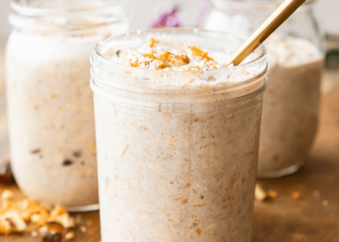 3 Carrot Cake Overnight Oats in mason jars with chopped walnuts