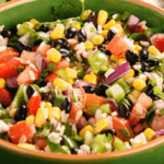 Bowl of salsa with corn, black beans, scallions, tomatoes