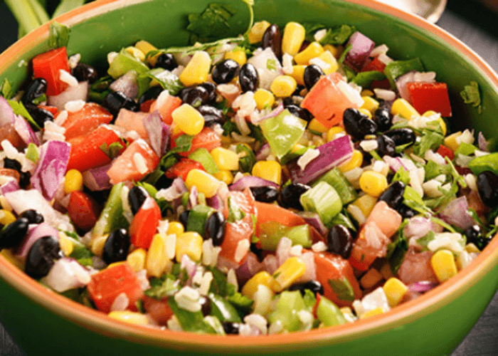 Bowl of salsa with corn, black beans, scallions, tomatoes