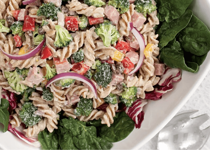 Pasta salad with greens, broccoli, red onion, diced ham