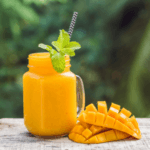 Smoothie with mangos and a halved mango