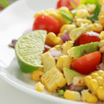 Summer salad with lime, avocado, corn, tomatoes