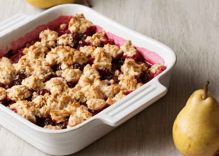 Blueberry pear crisp in a dutch oven with pear
