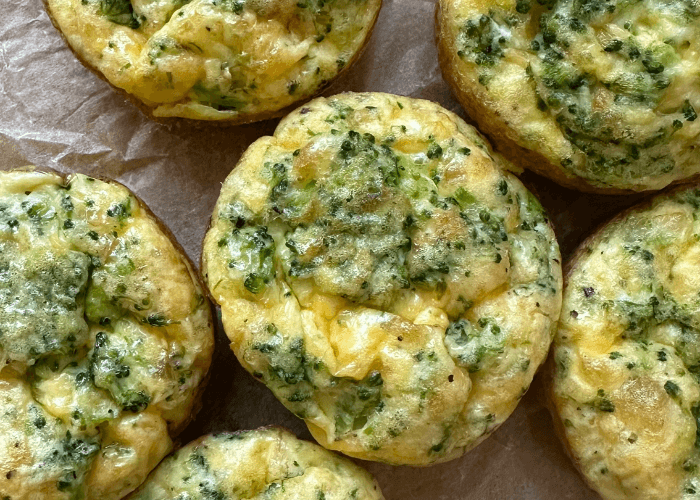 Broccoli Cheddar Egg Bites on parchment paper