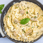 One-Pot Chicken Alfredo in a skillet with fresh basil