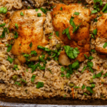 baking dish with chicken thighs and brown rice