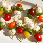 Caprese Skewers with mozzarella balls, basil leaves, and cherry tomatoes