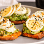 Sweet Potato slices with avocado, egg, and seasonings