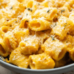 Butternut Squash Mac and Cheese with a fork in a black bowl