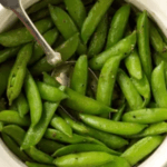 Zesty Sugar Snap Peas in a white bowl