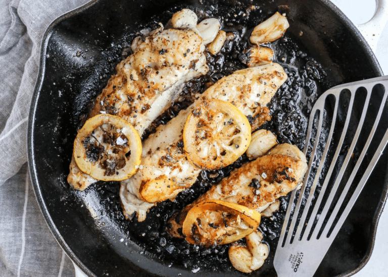 monkfish in a pan with lemon slices